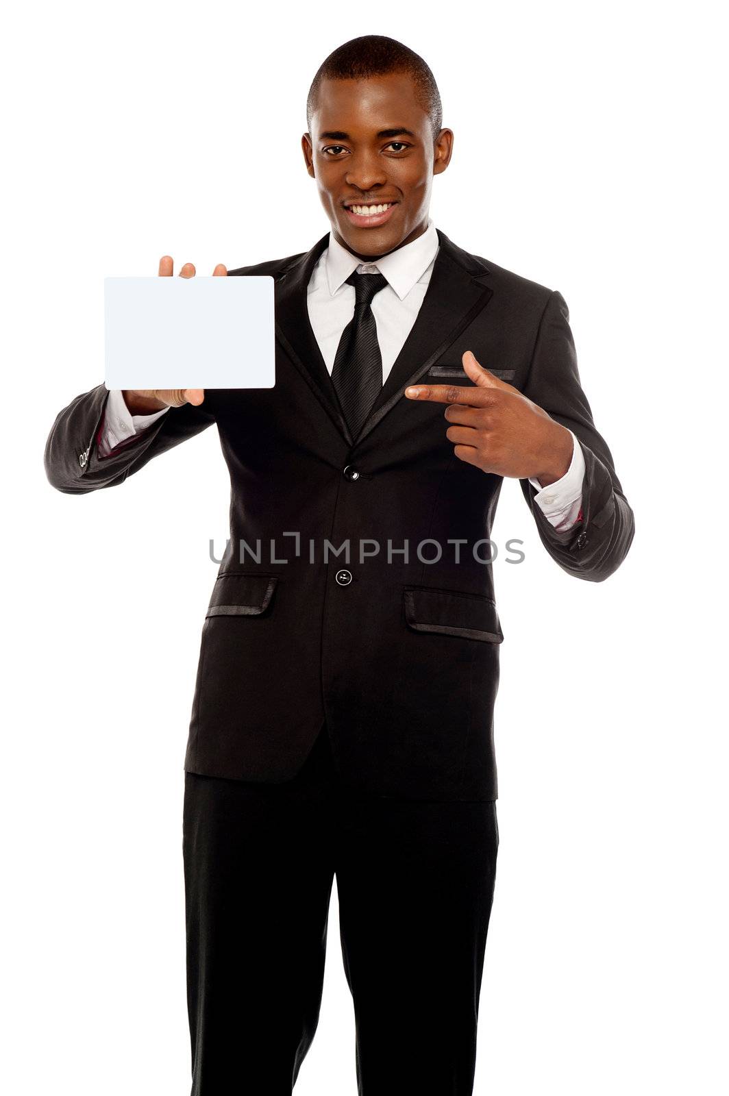 Business promoter pointing at blank placard looking right into camera