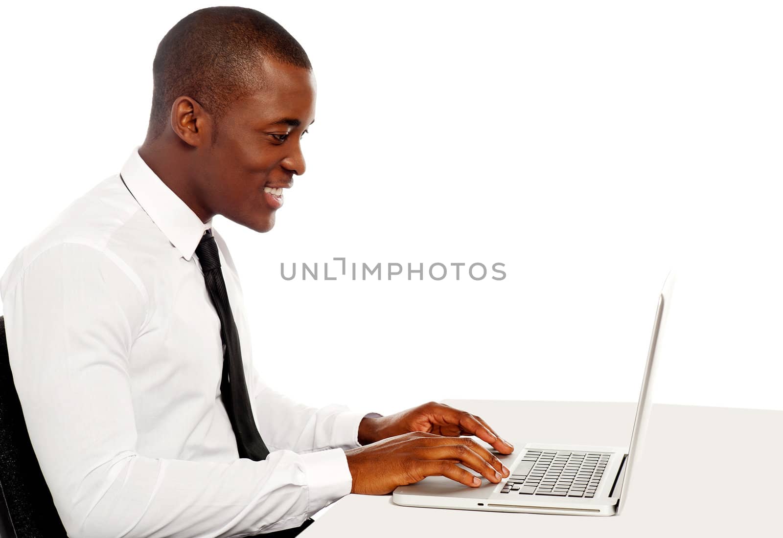 Side view portrait of handsome business executive working on laptop