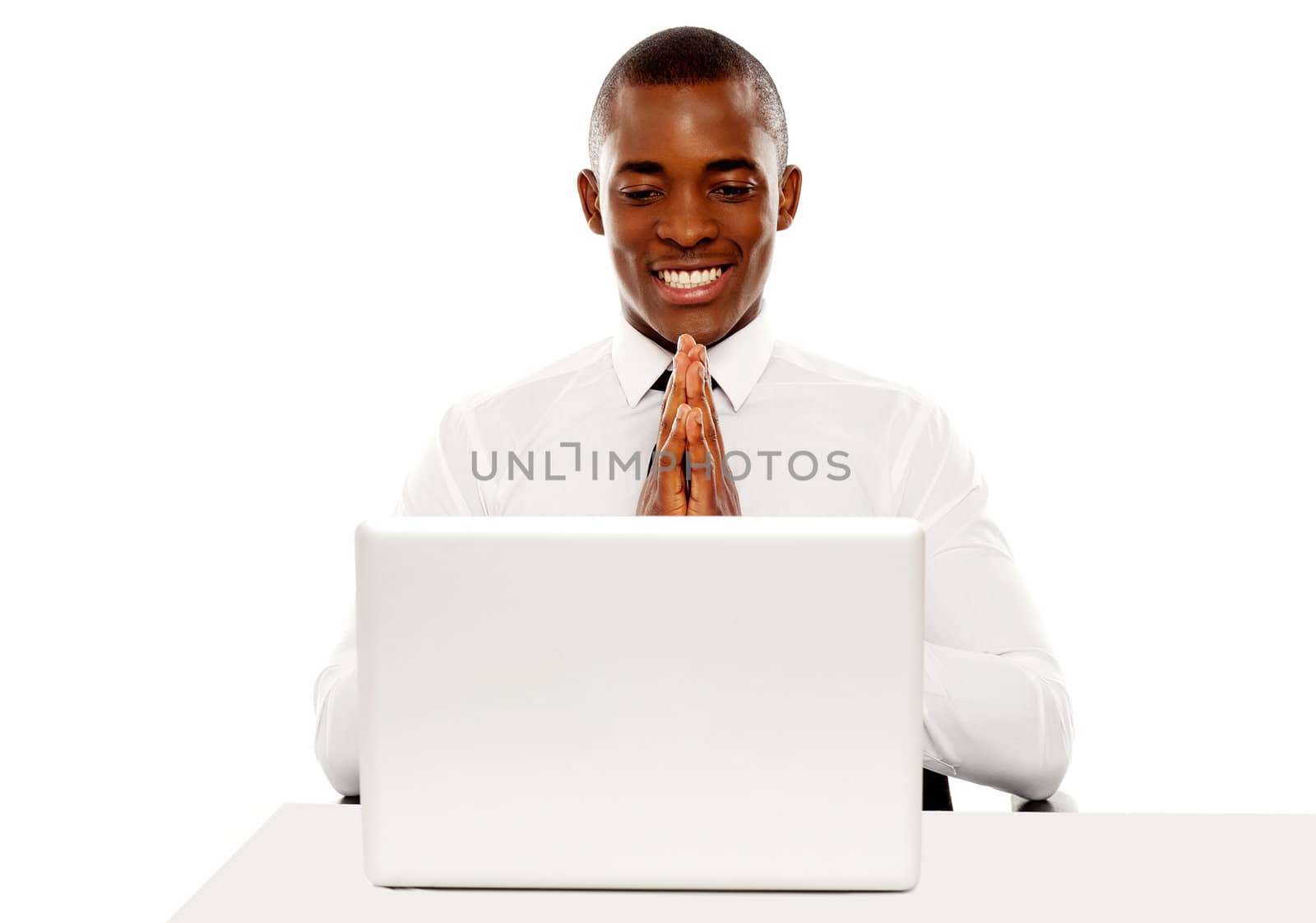 Cheerful african male manager looking at laptop screen, business concept