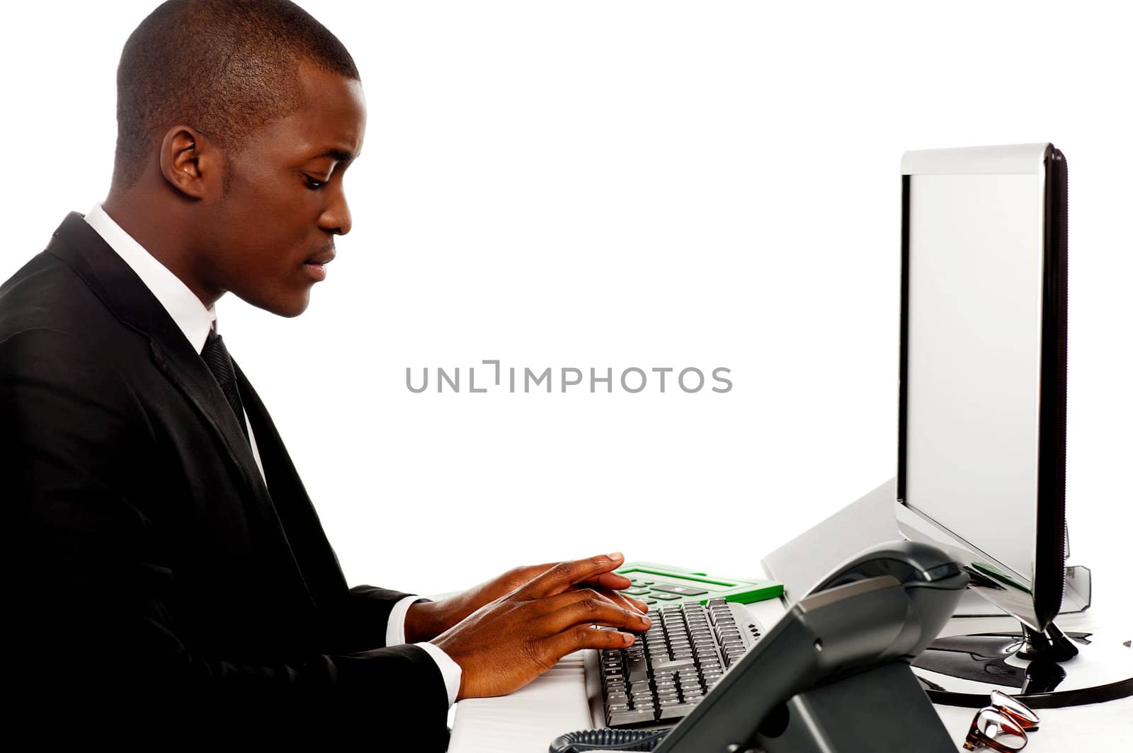 Side view male secretary typing on keyboard working on computer