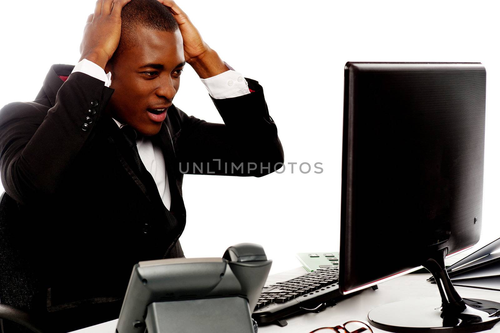 Irritated african man angry on computer at work