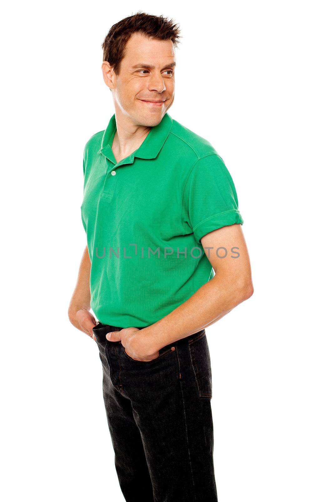Handsome young man with hands in pocket looking away, turning head back