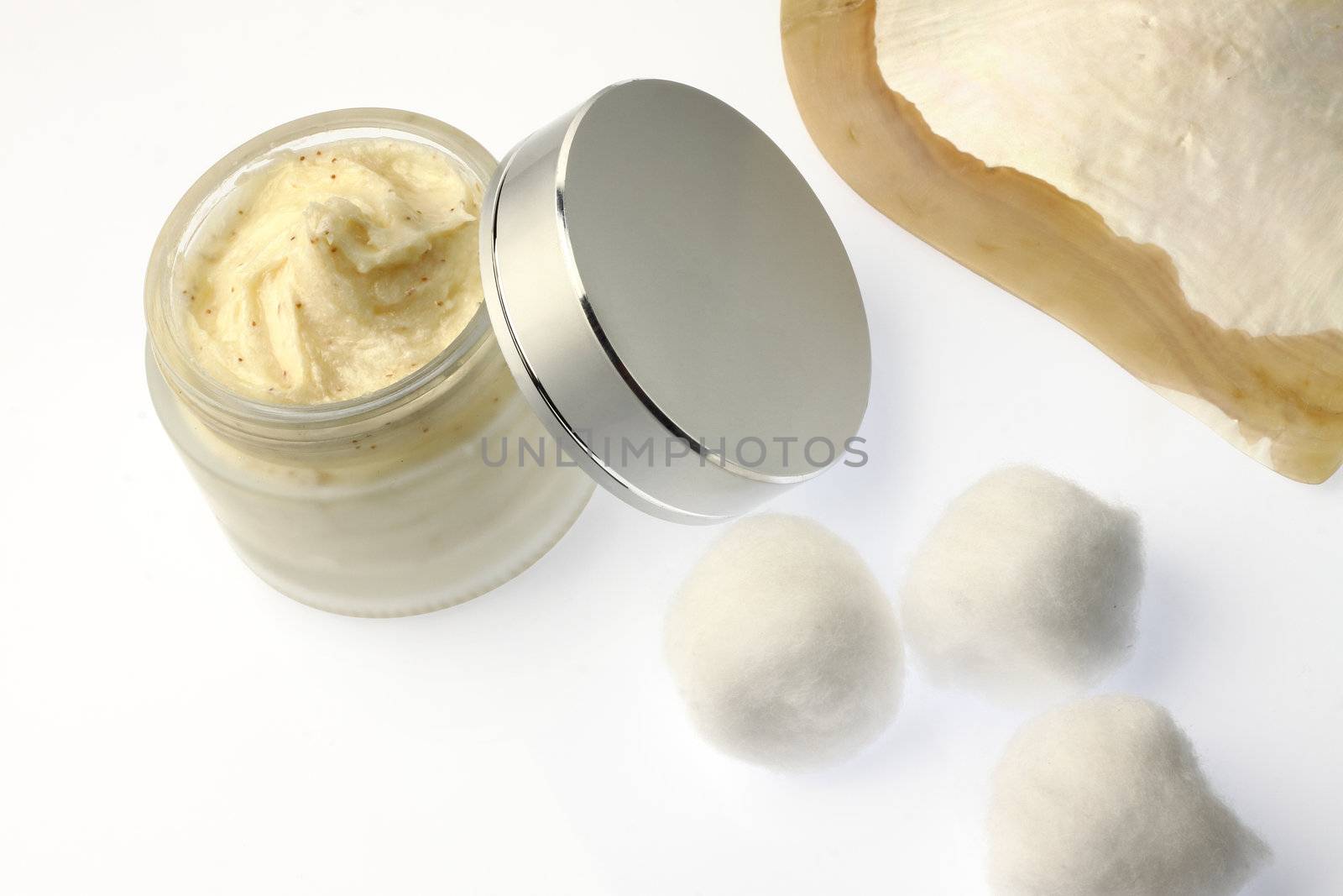 body scrub in packaging with cotton on white background