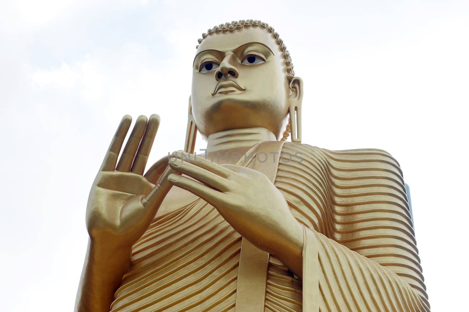 Bottom view of a historic giant golden buddha statue in Sri Lanka