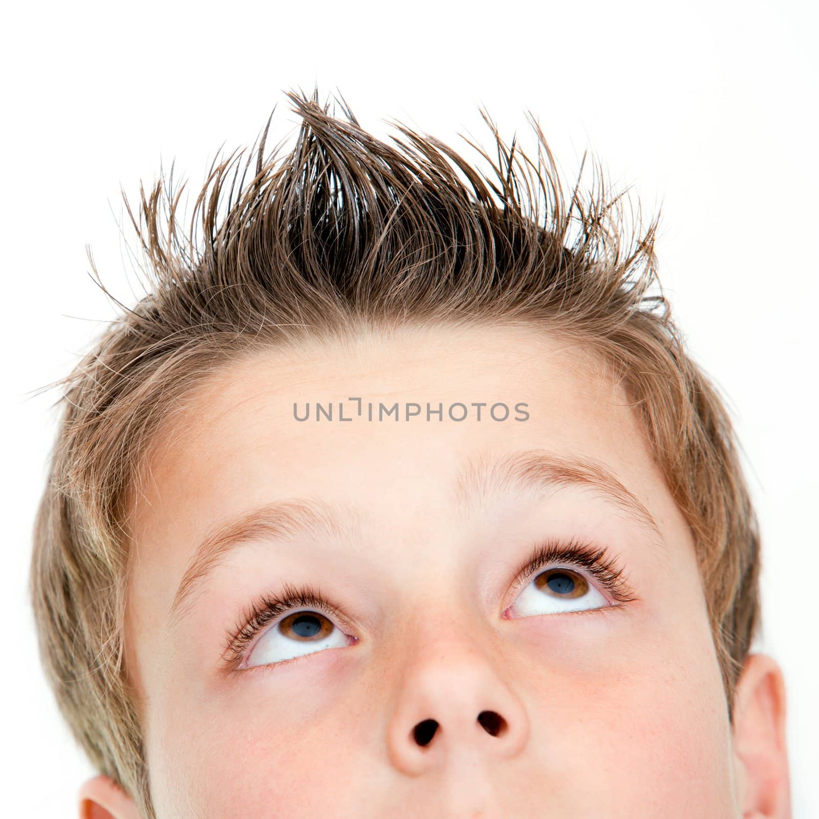 Extreme close up of boy looking up. by karelnoppe