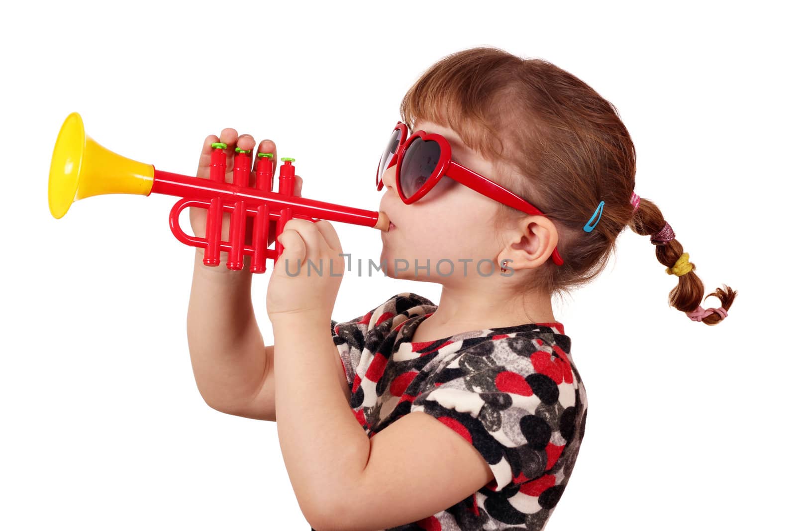 little girl with sunglasses play trumpet