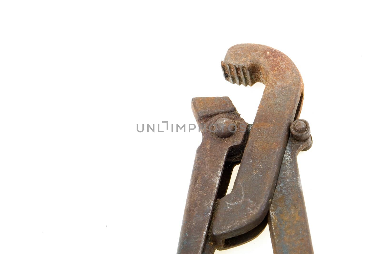 Big used rusty wrench on white background.