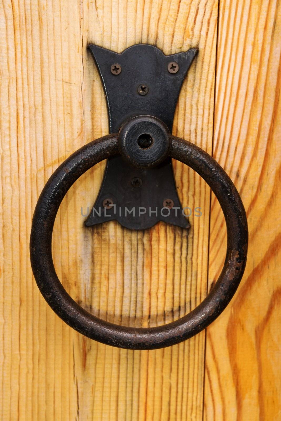 Metal rusty round handle on wooden door