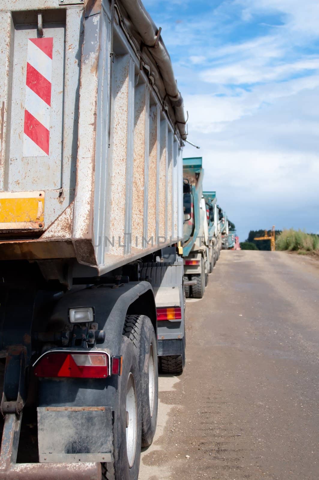 Row of Dump Trucks and Earth Moving Equipment at a Highway Construction Site in Germany