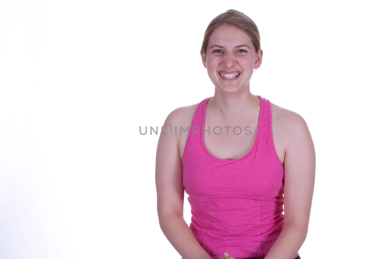 A pretty young woman in work  out clothes, smiling.  There is a white background and copy space.