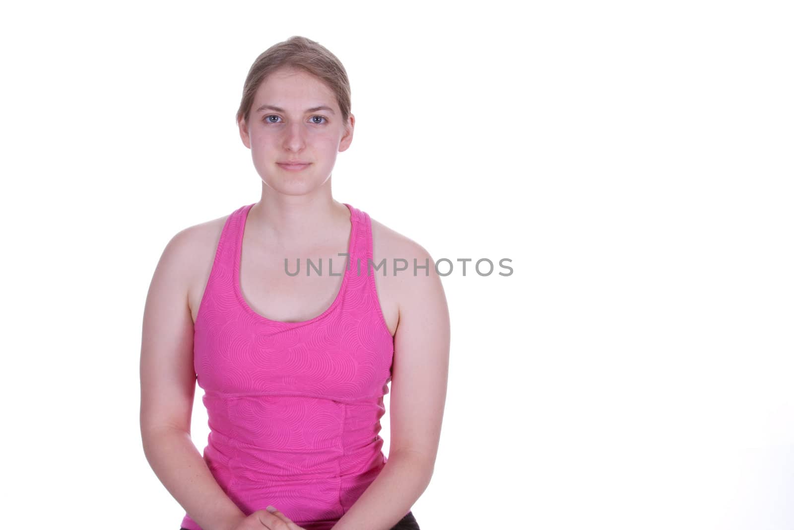 A pretty young woman in work  out clothes, smiling.  There is a white background and copy space.