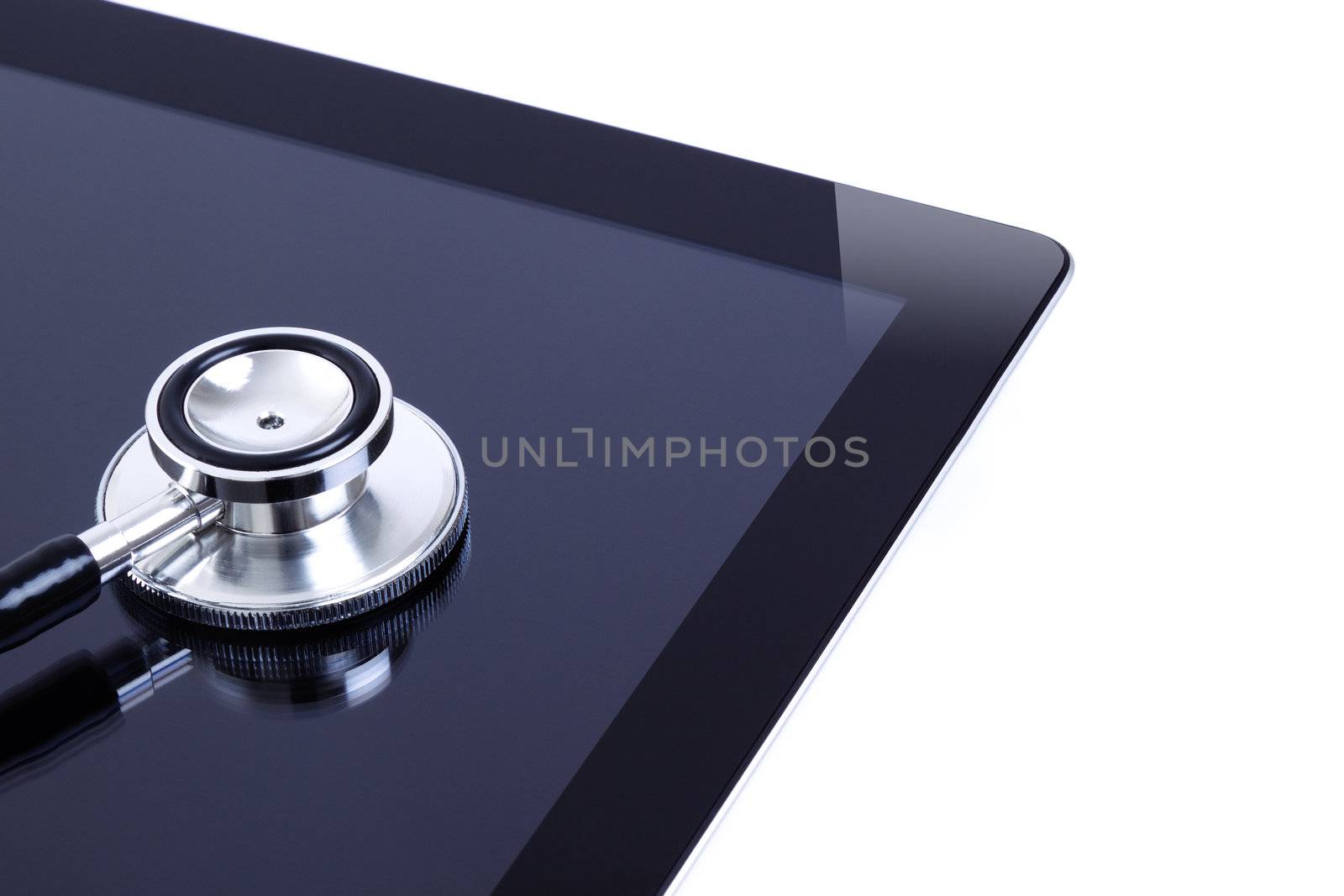 Photo of a digital touch screen tablet with dual head high quality stethoscope. Focus on stethoscope. Isolated on white background.