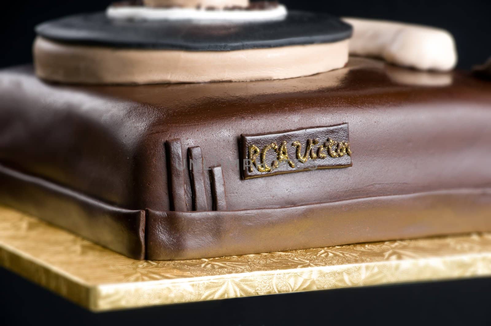 Close up of cake turtable on isolated black background