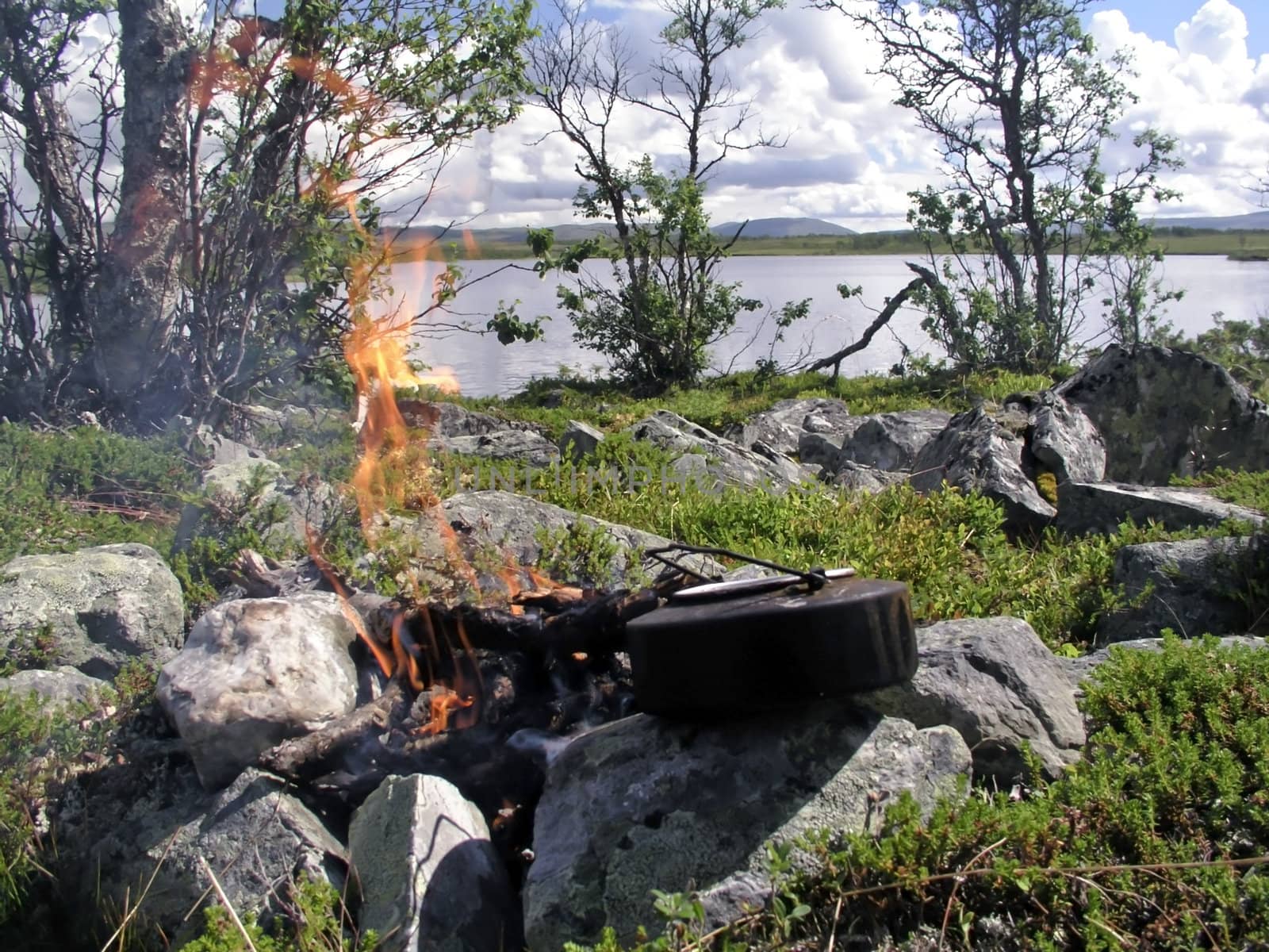 Camp fire by the lake
