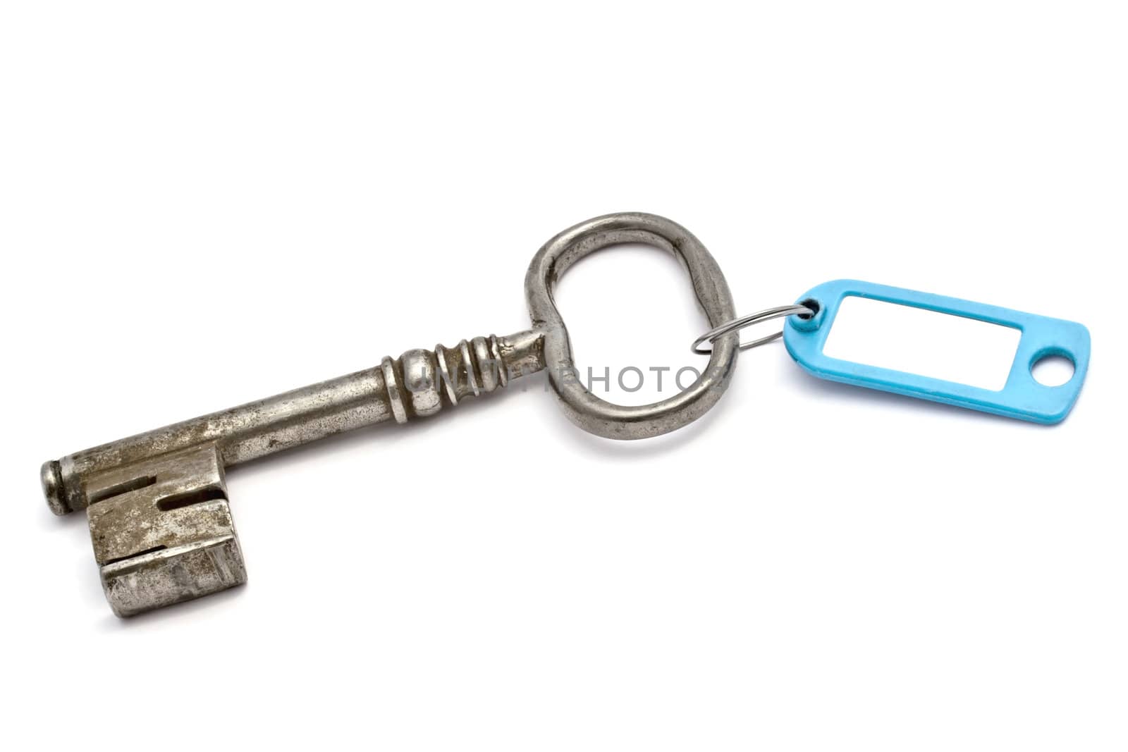 Key with a success tag closeup on white background 
