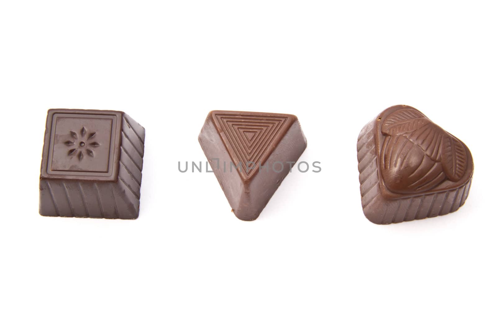 Delicious chocolates closeup on white background 