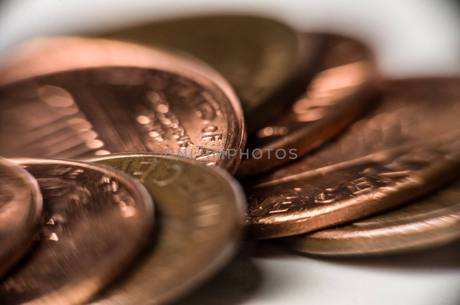 Macro shot of copper pennies on white.