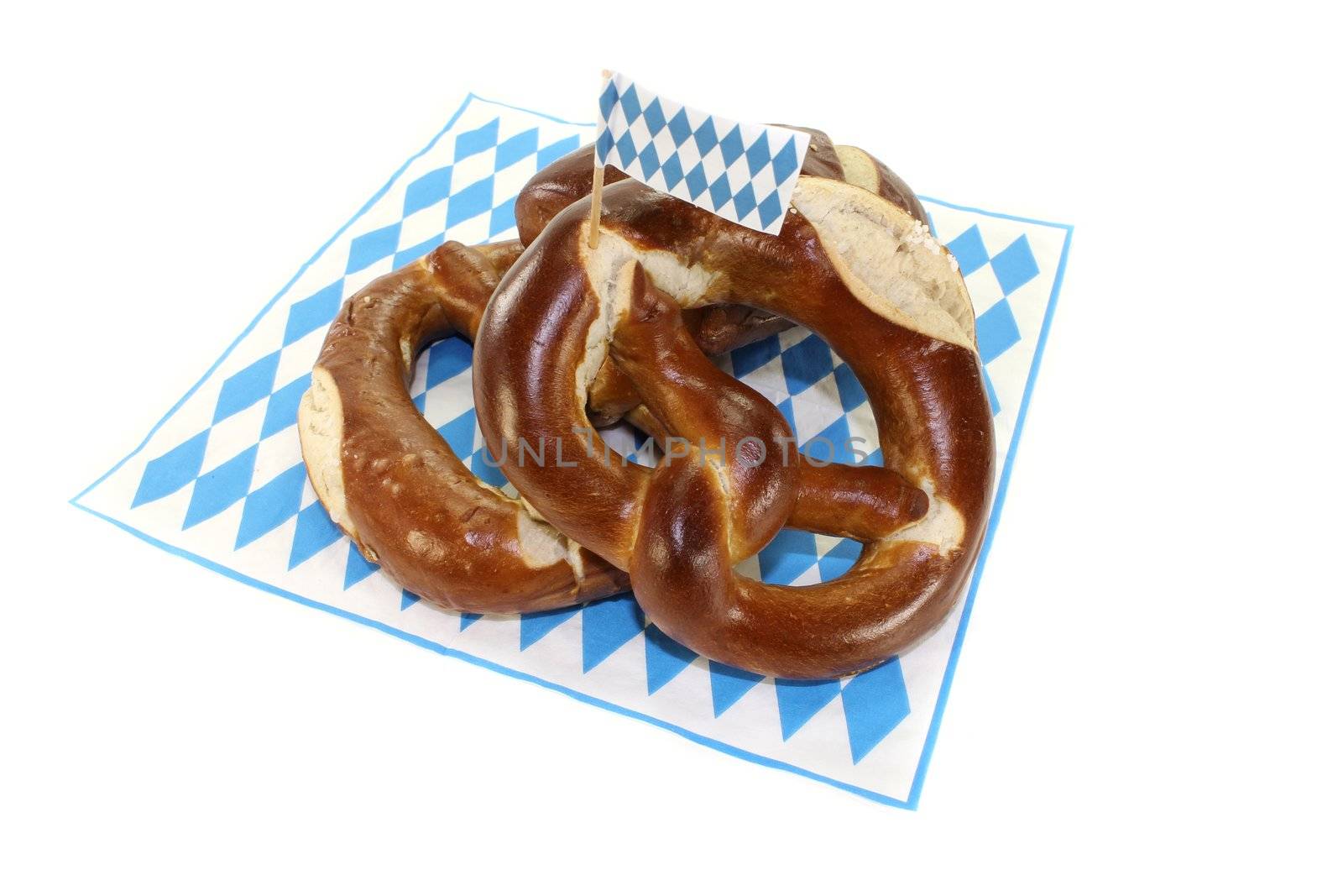 baked Bavarian pretzels with salt on a light background