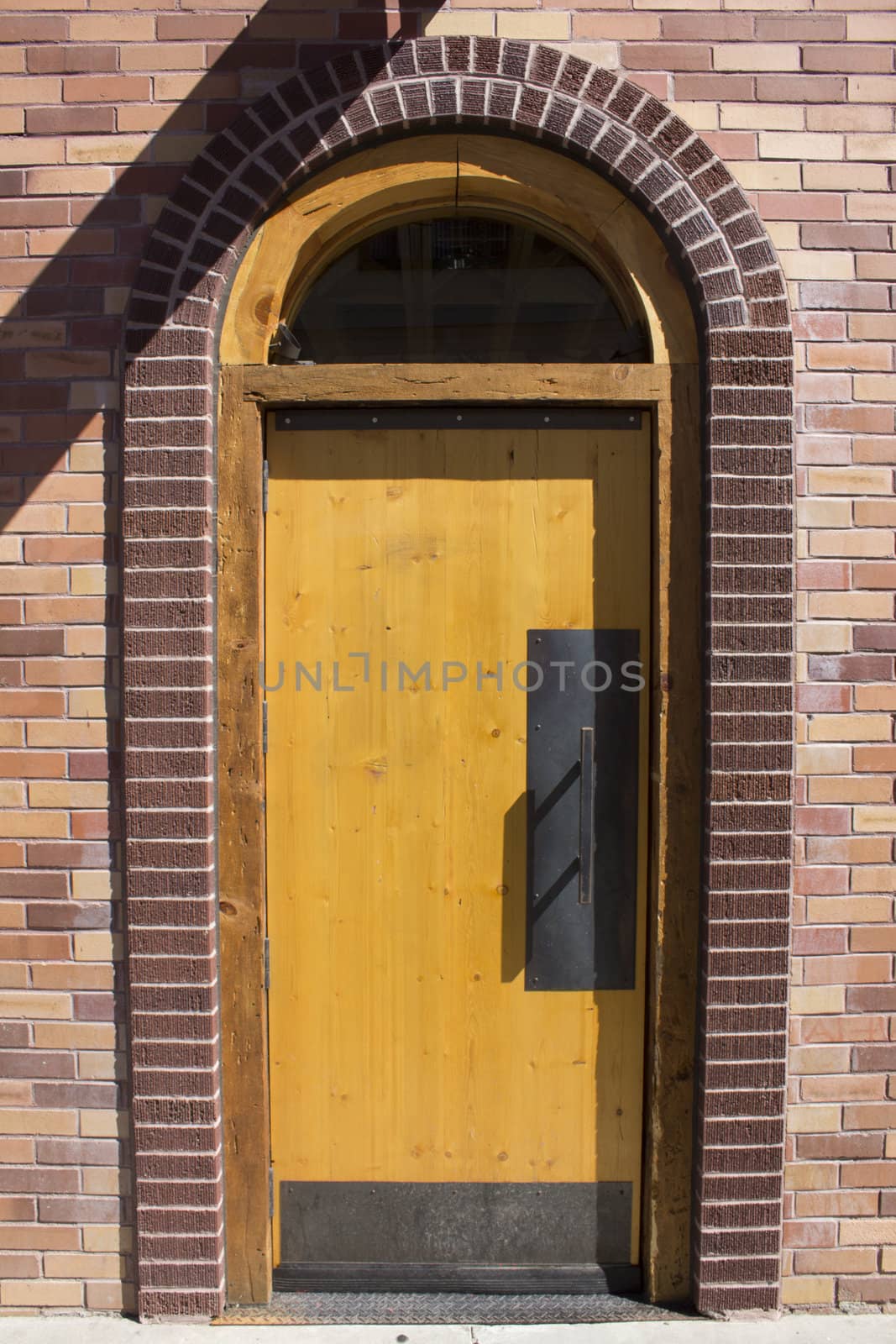 A brick door with an arch in a brick building.