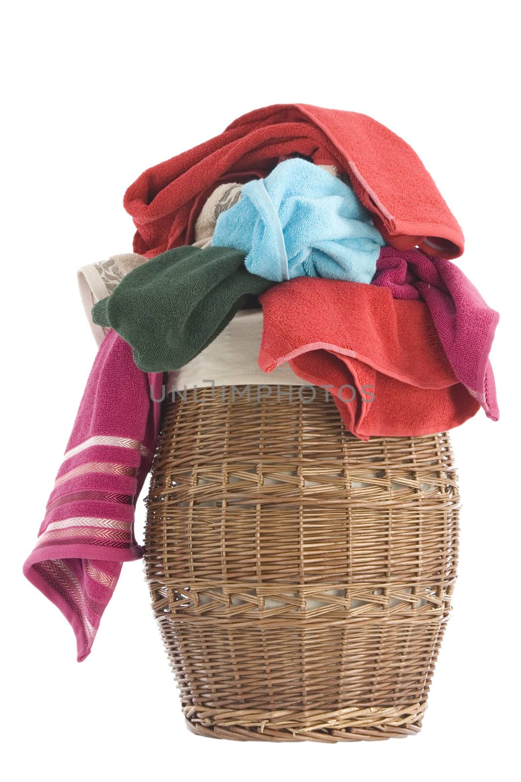 colorful towels in a basket isolated on white background 