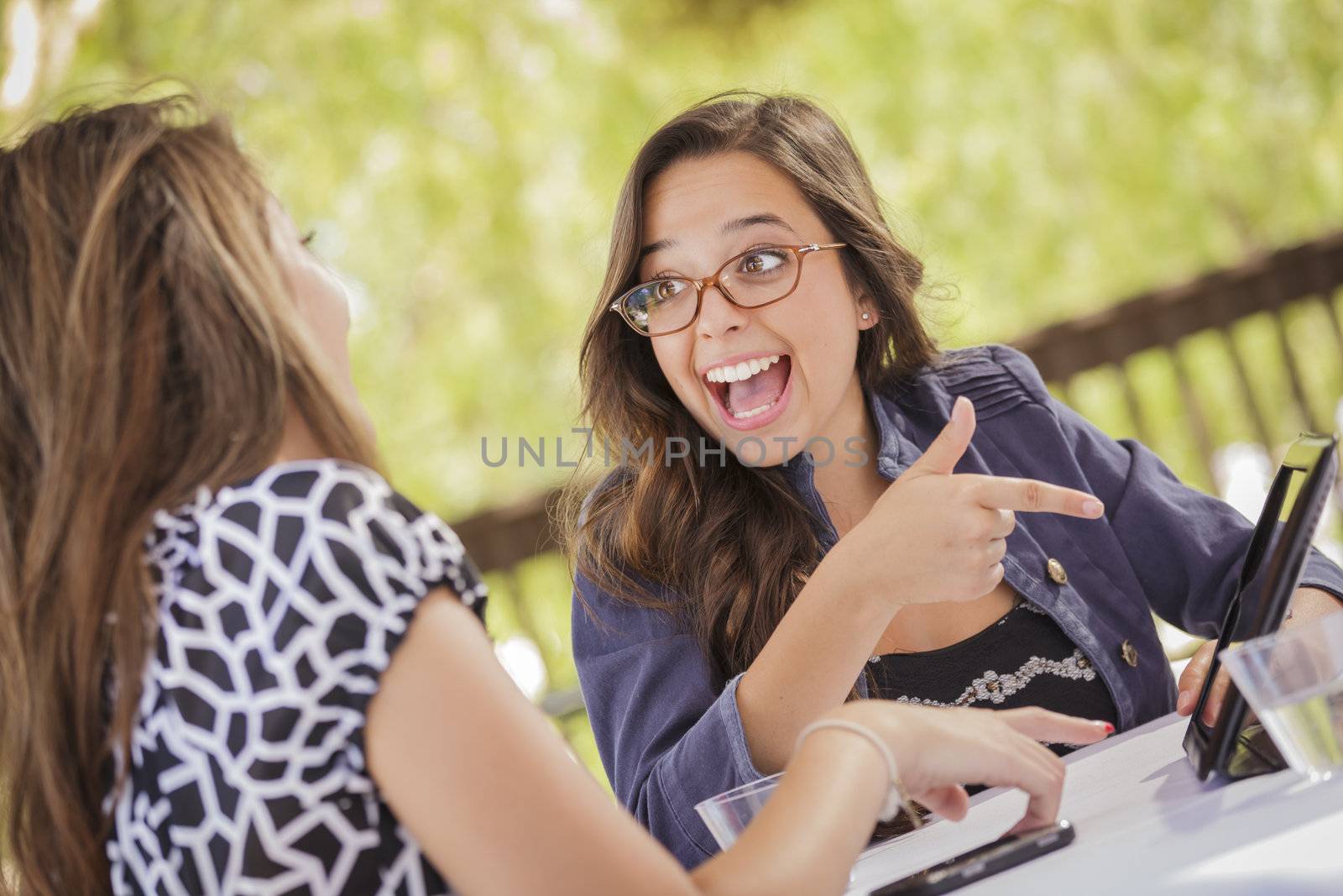 Mixed Race Girls Working Together on Tablet Computer by Feverpitched