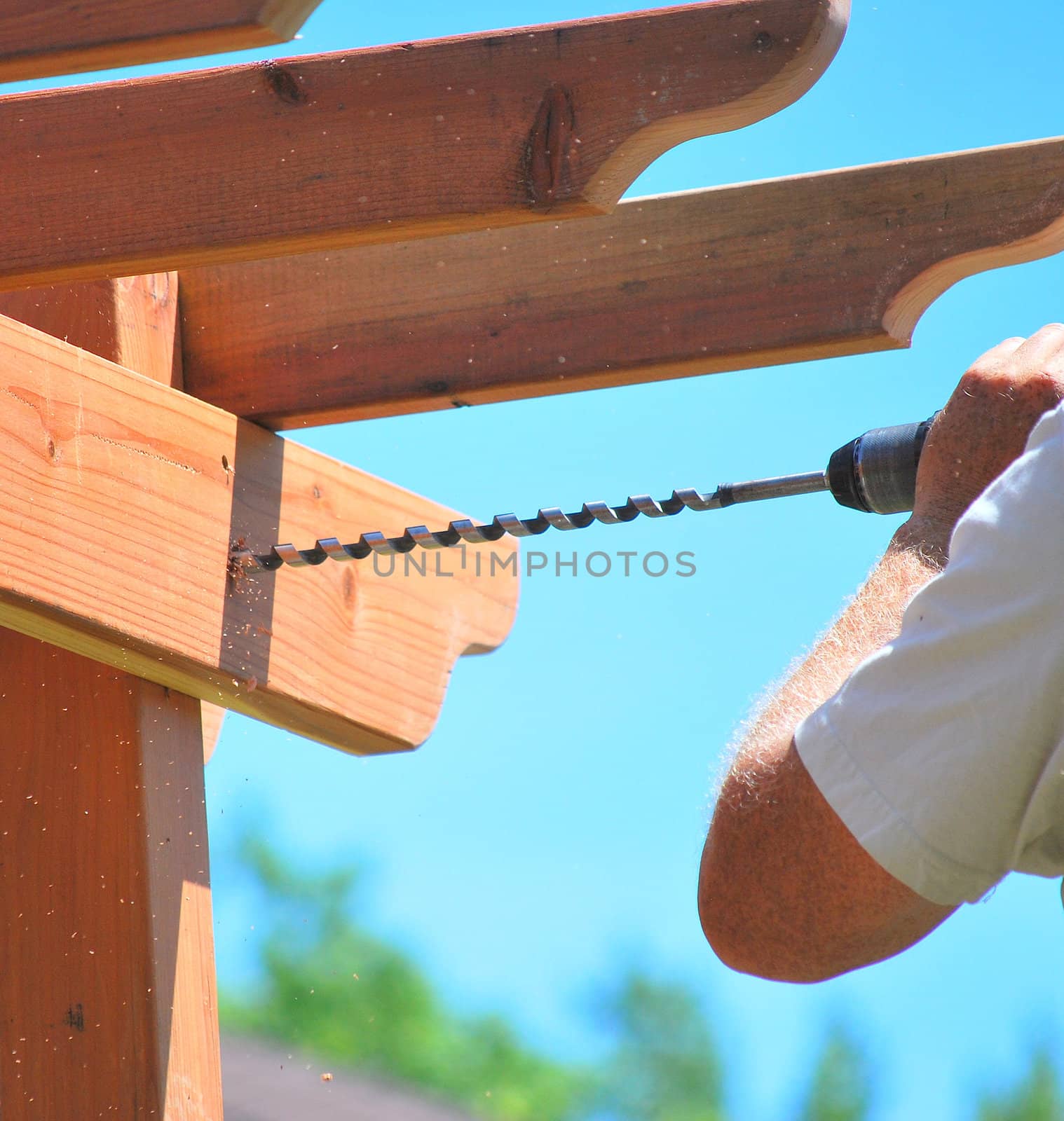 Male carpenter building a new home patio deck.