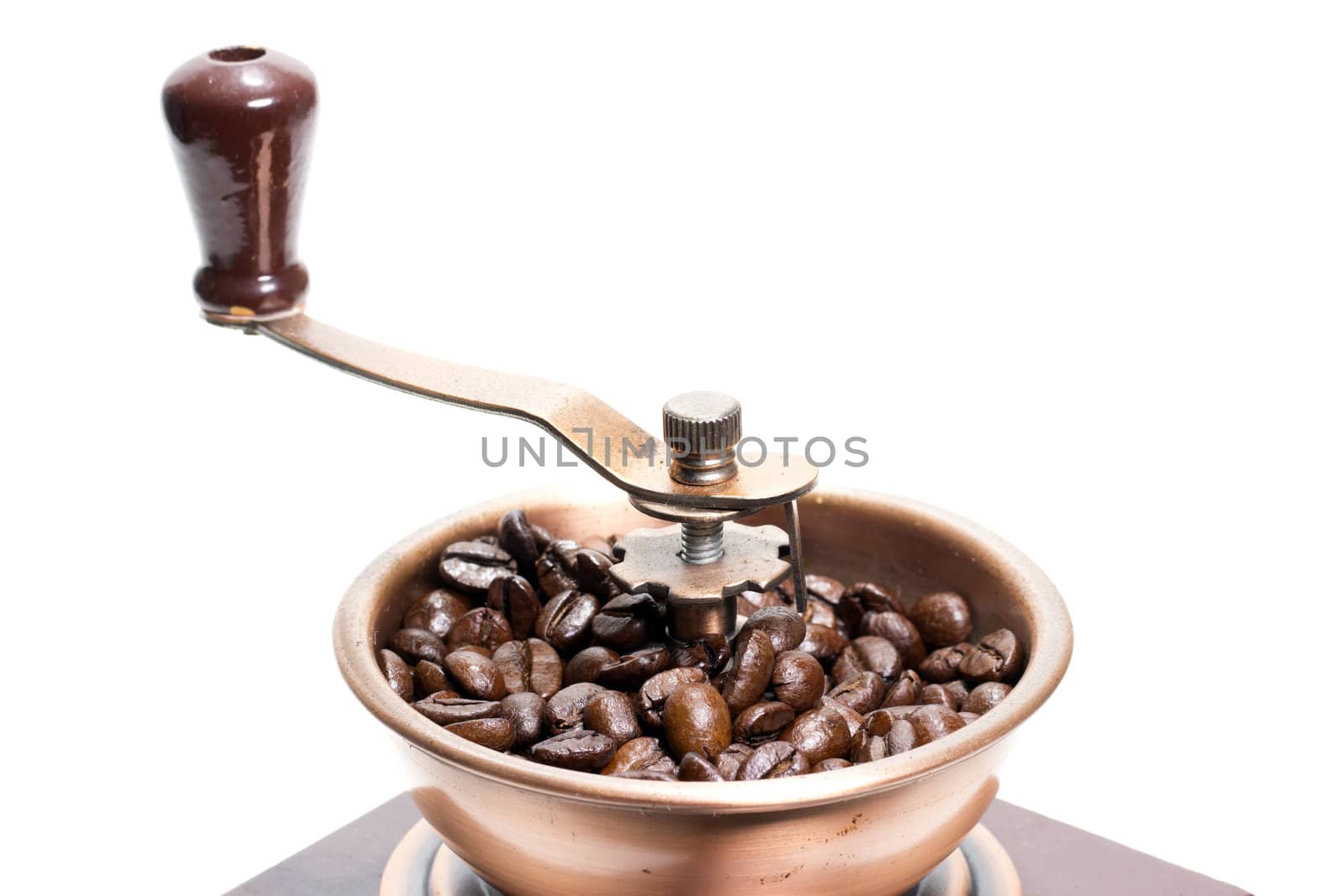 Fresh roasted coffee beans in the manual coffee grinder on white background