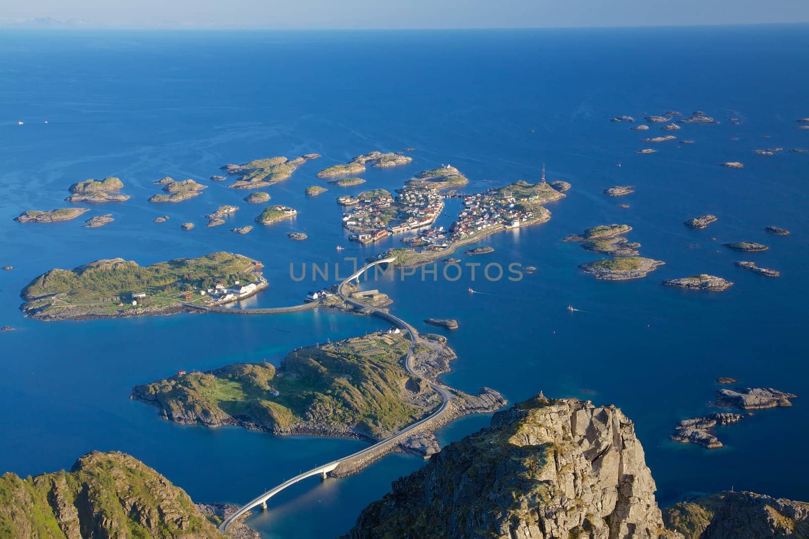 Scenic town of Henningsvaer on Lofoten islands in Norway with large fishing harbour and bridges connecting rocky islands