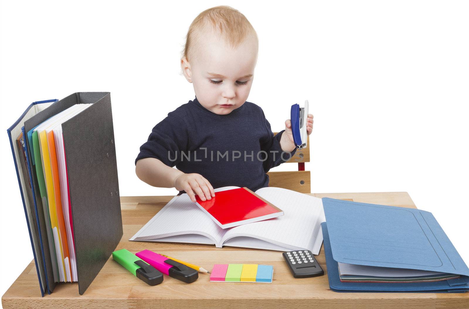 young child working at writing desk in light background