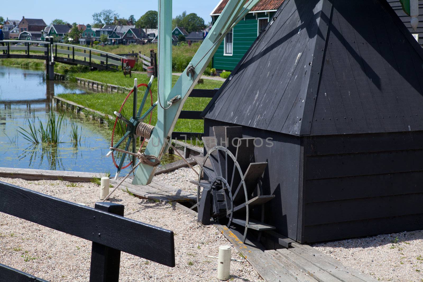 part of black wooden water mill in Dutch town