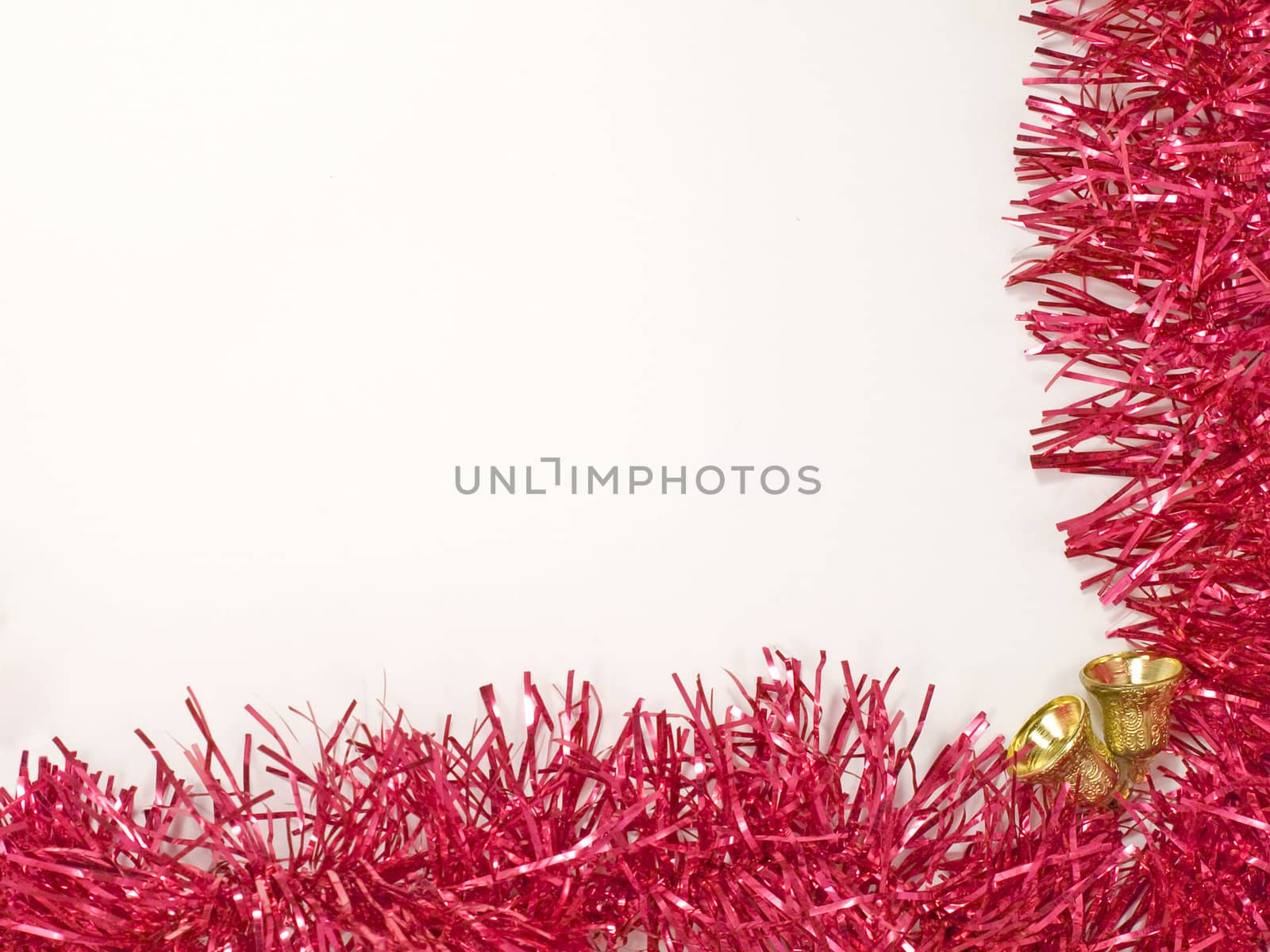 Golden christmas bells and red decoration on white background.