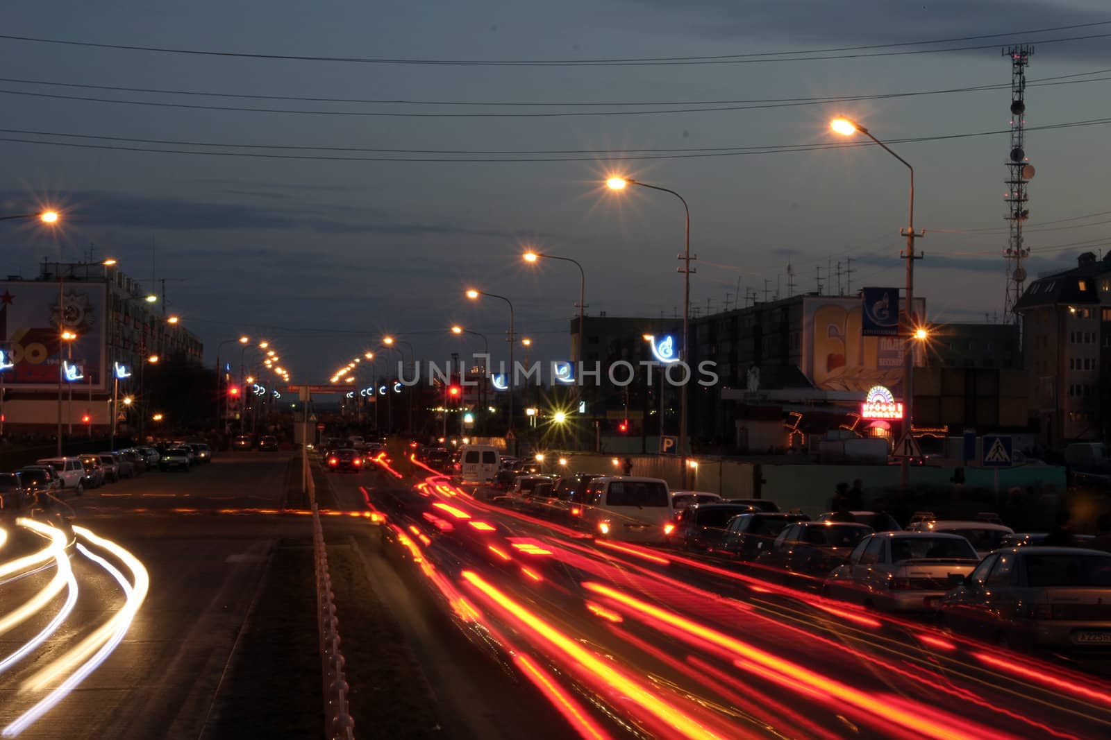 Night street with traces from light of headlights shined with street lanterns