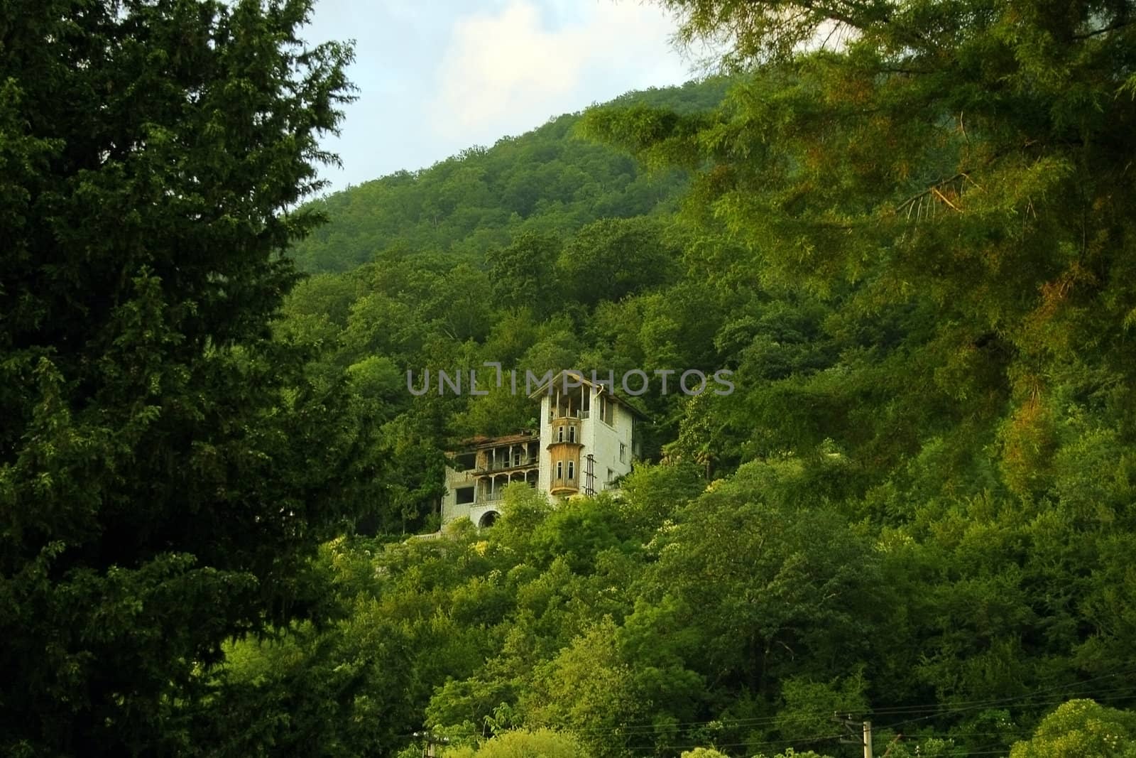 Standing alone at mountain top an old small house in a wood environment
