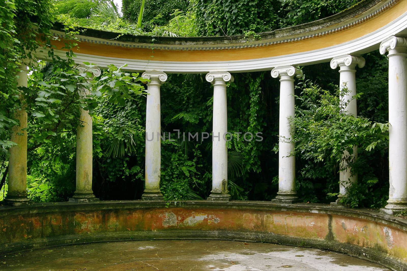 Light columns in classical style in an environment of green vegetation