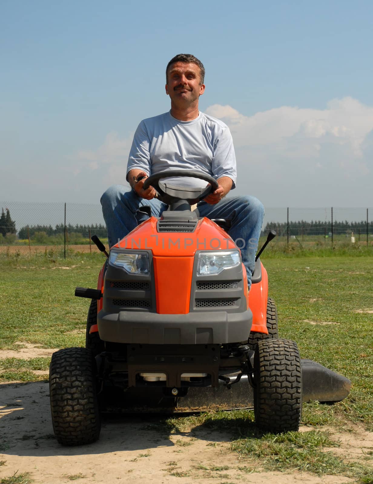 man on his lauwn mower in a big garden