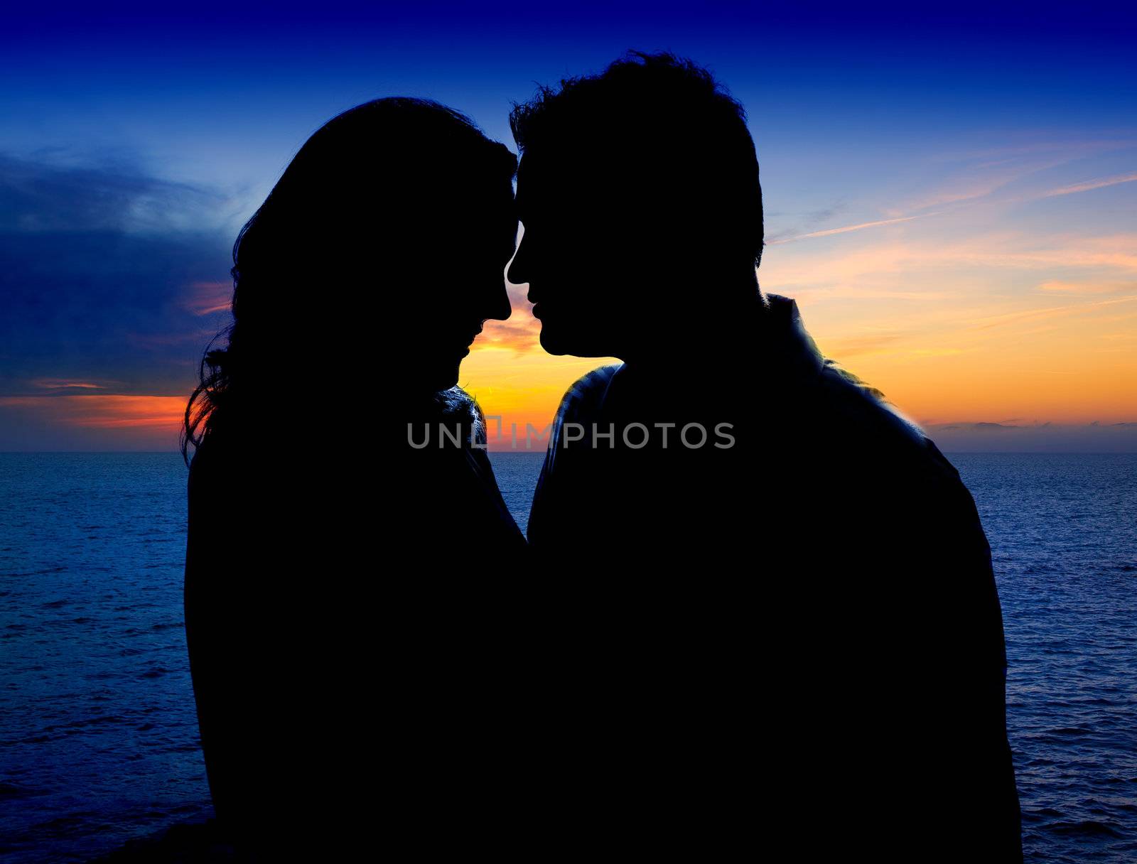 Couple in love hug in sunset on sea lake