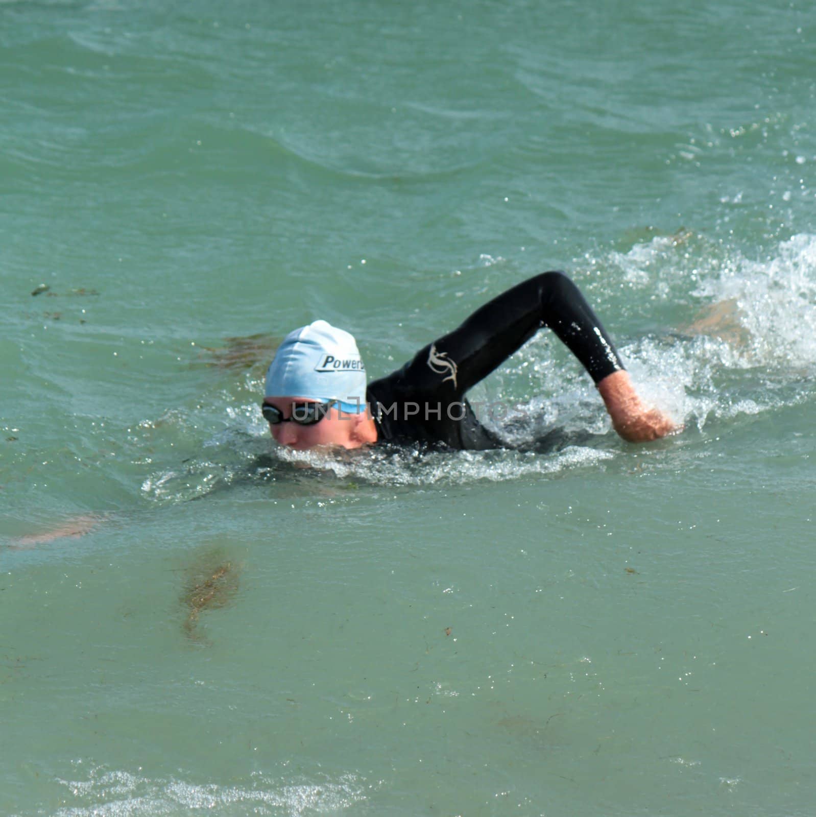 GENEVA, SWITZERLAND - JULY 22 : unidentified female athlet swimming at the International Geneva Triathlon, on July 22, 2012 in Geneva, Switzerland.