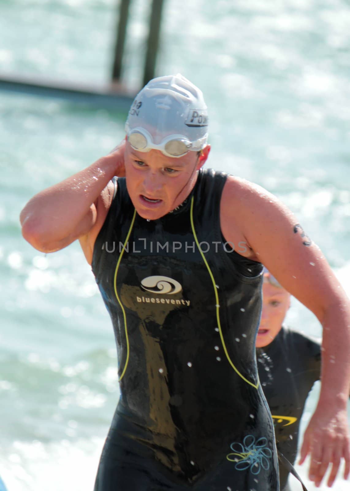 GENEVA, SWITZERLAND - JULY 22 : unidentified female athlet going out of water at the International Geneva Triathlon, on July 22, 2012 in Geneva, Switzerland.