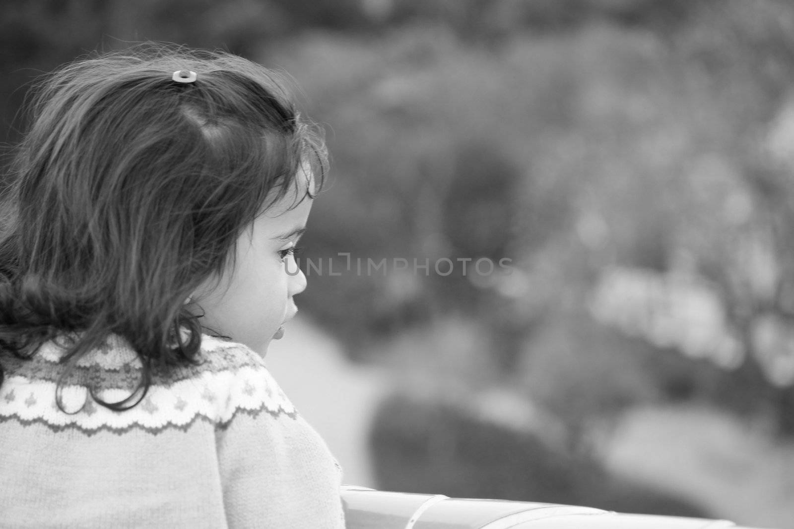 Portrait of small cute girl looking to side with copy space