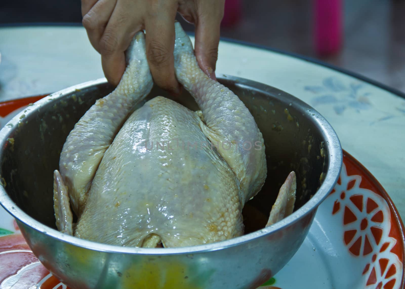 Preparing stuffed chicken in stainless bowl