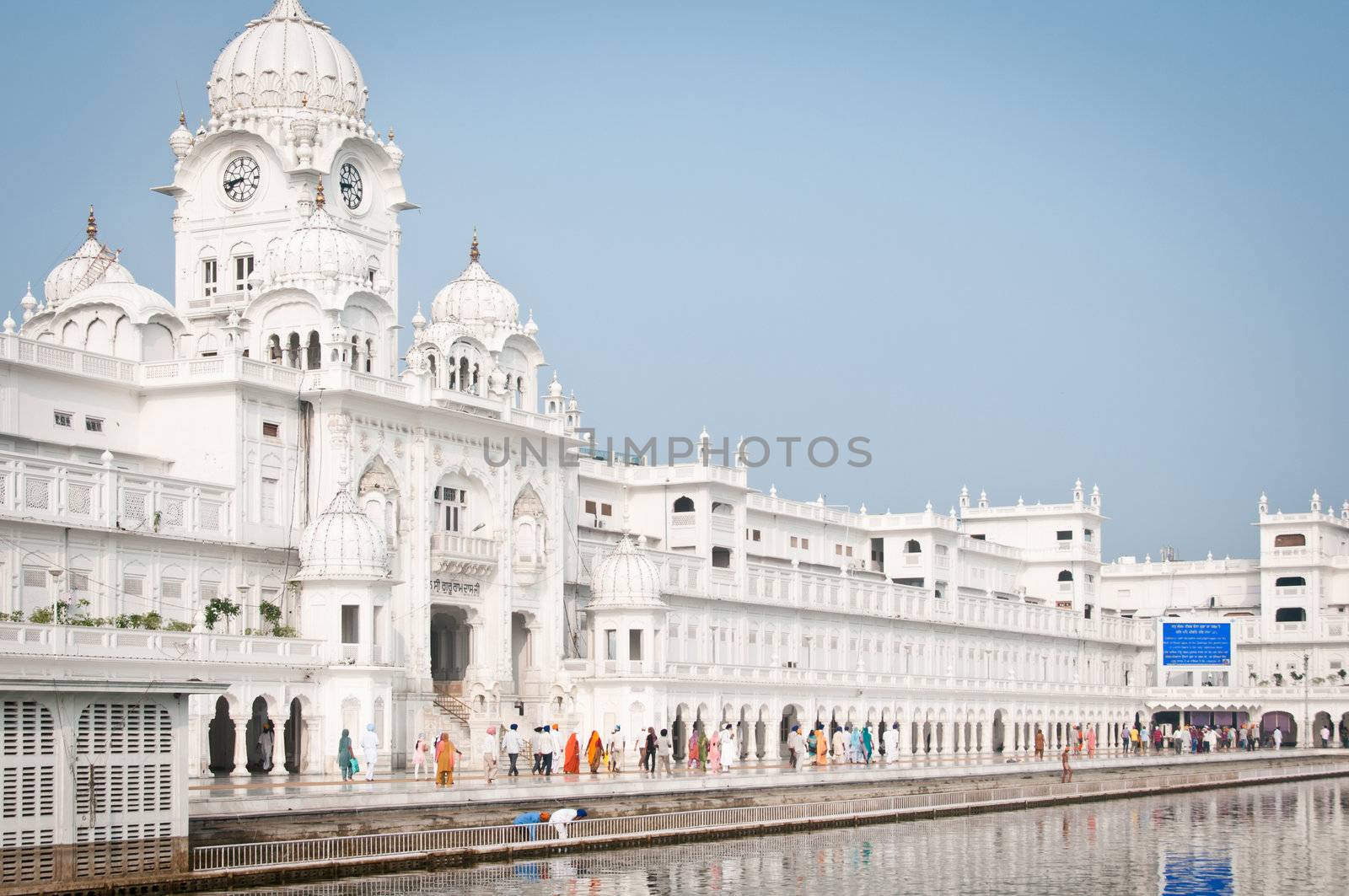 Amritsar, India - August 26, 2011: Pilgrims walk in the Harmandir Sahib Complex, the spiritual and cultural center of the Sikh religion
