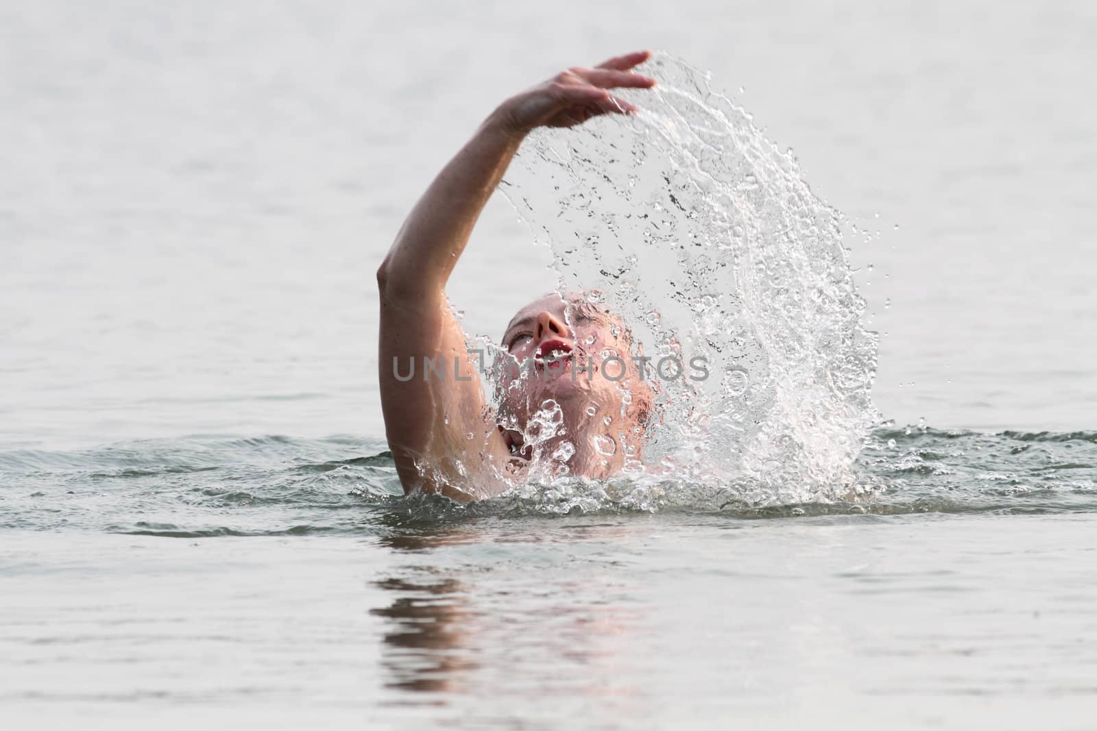 Smiling woman swimming in the water