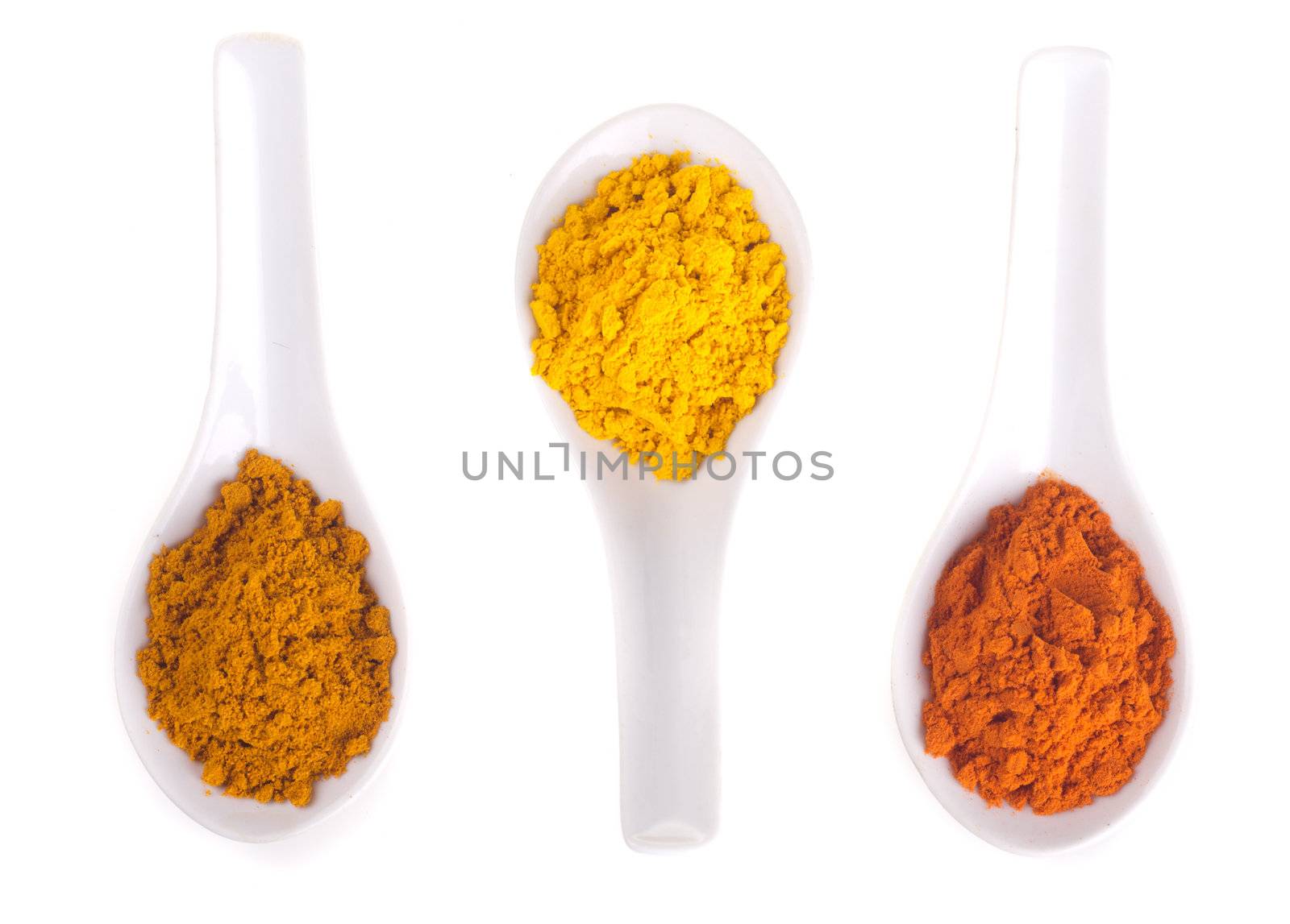 spices in the spoons on a white background