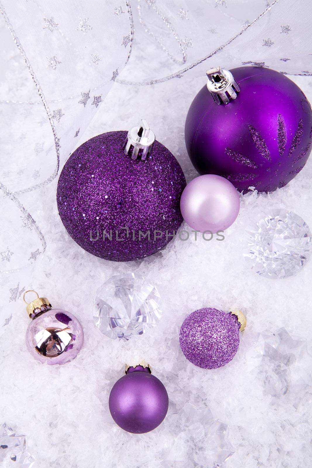 beautiful christmas decoration in purple and silver on white snow sparkle
