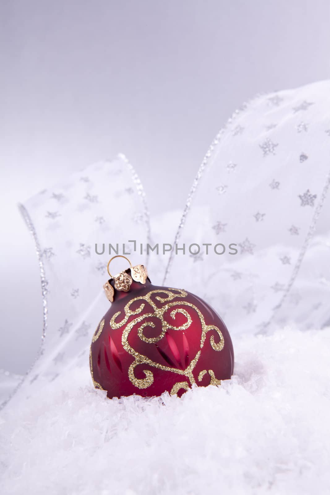 beautiful gold and red christmas decoration on white snow sparkle