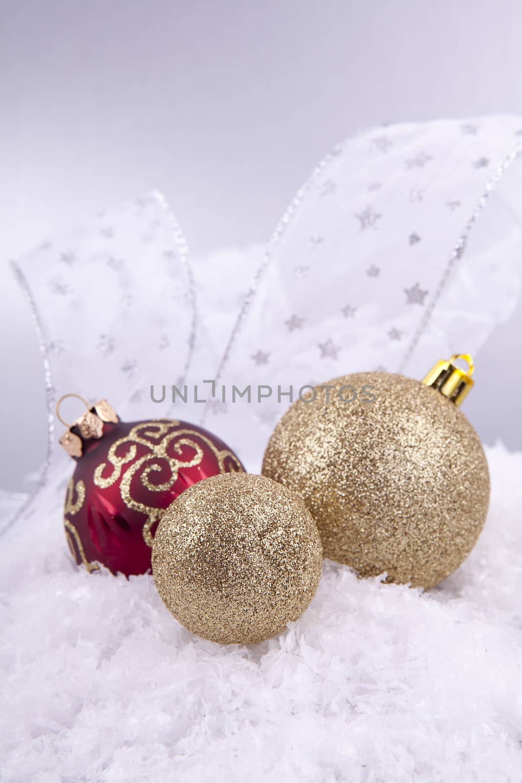 beautiful gold and red christmas decoration on white snow sparkle