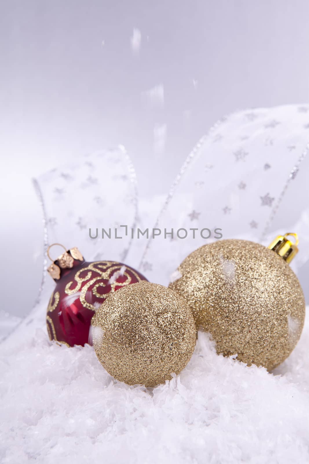 beautiful gold and red christmas decoration on white snow sparkle