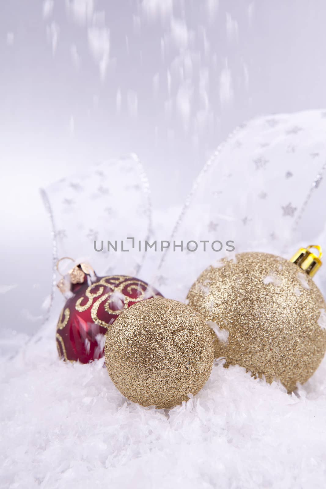 beautiful gold and red christmas decoration on white snow sparkle