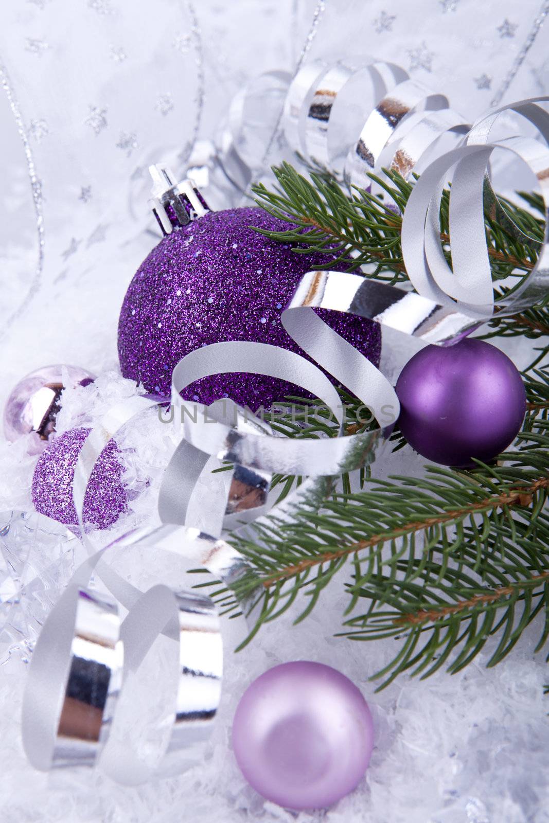 beautiful christmas decoration in purple and silver on white snow sparkle