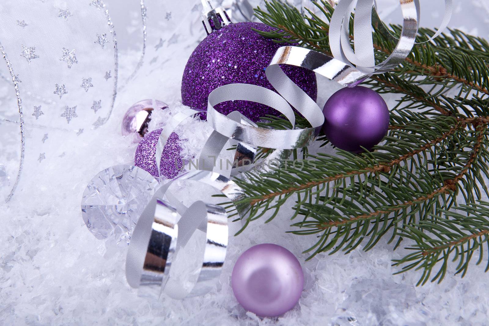 beautiful christmas decoration in purple and silver on white snow sparkle